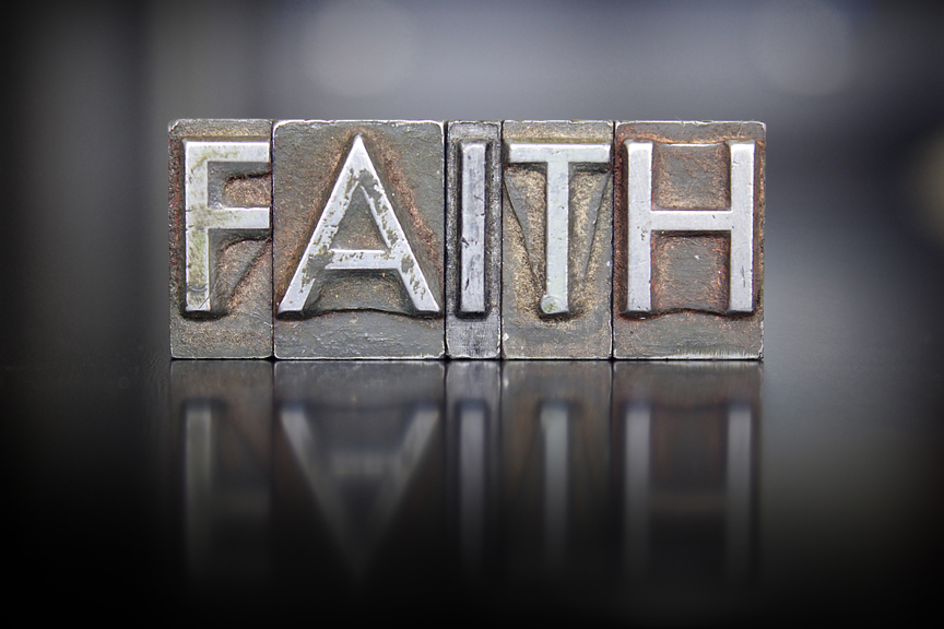 The word FAITH written in vintage letterpress type